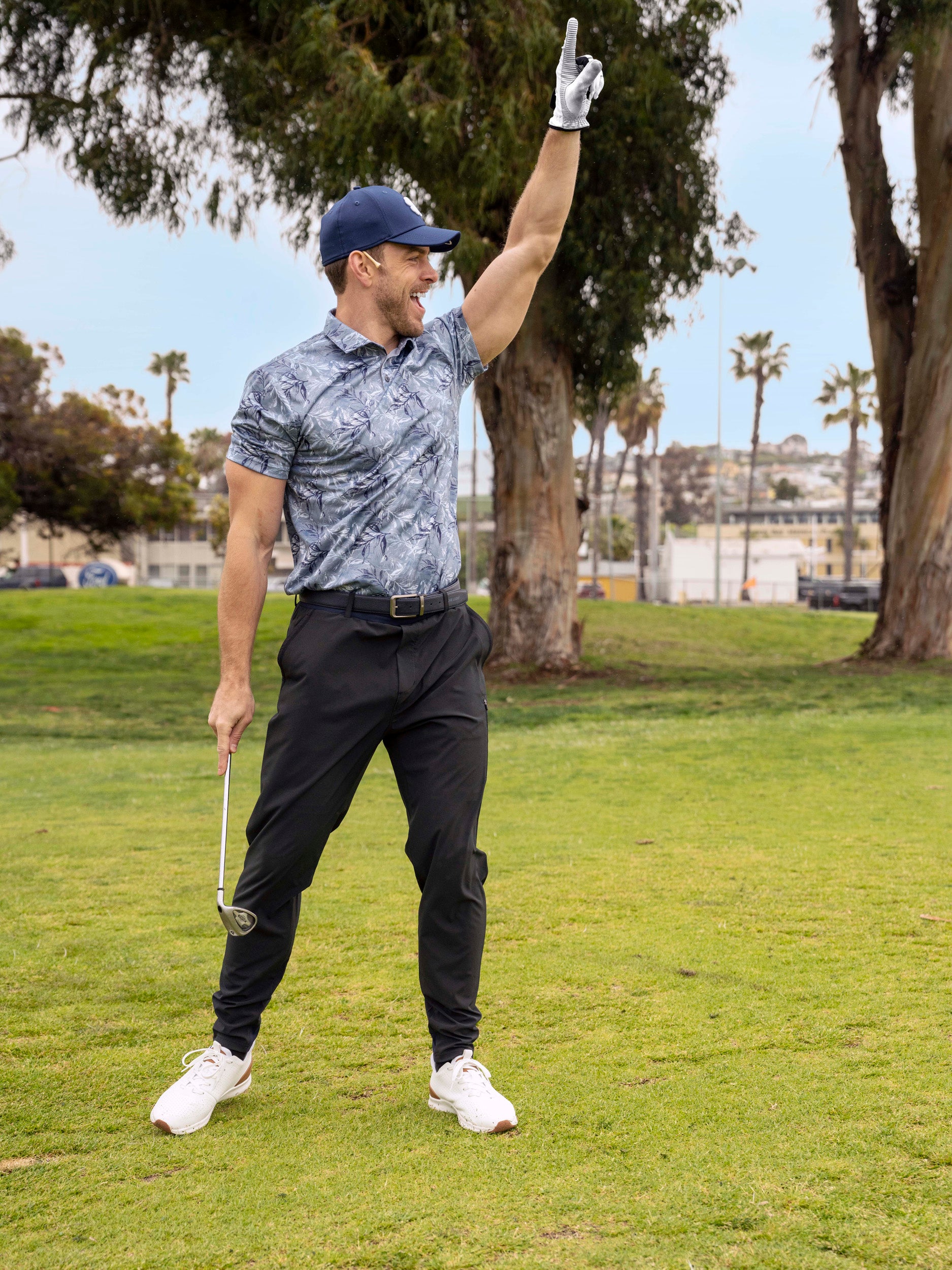 Man celebrating golf shot wearing Black Clover Live Lucky premium clover hat in blue.