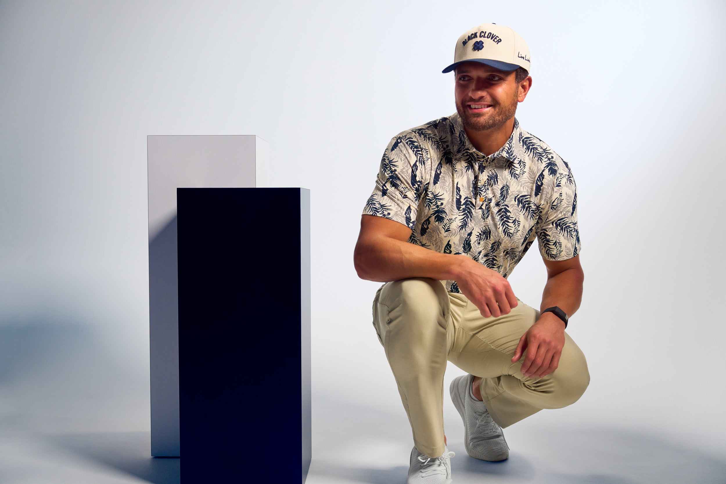 Man wearing a timeless Black Clover Live Lucky hat in creme and blue.