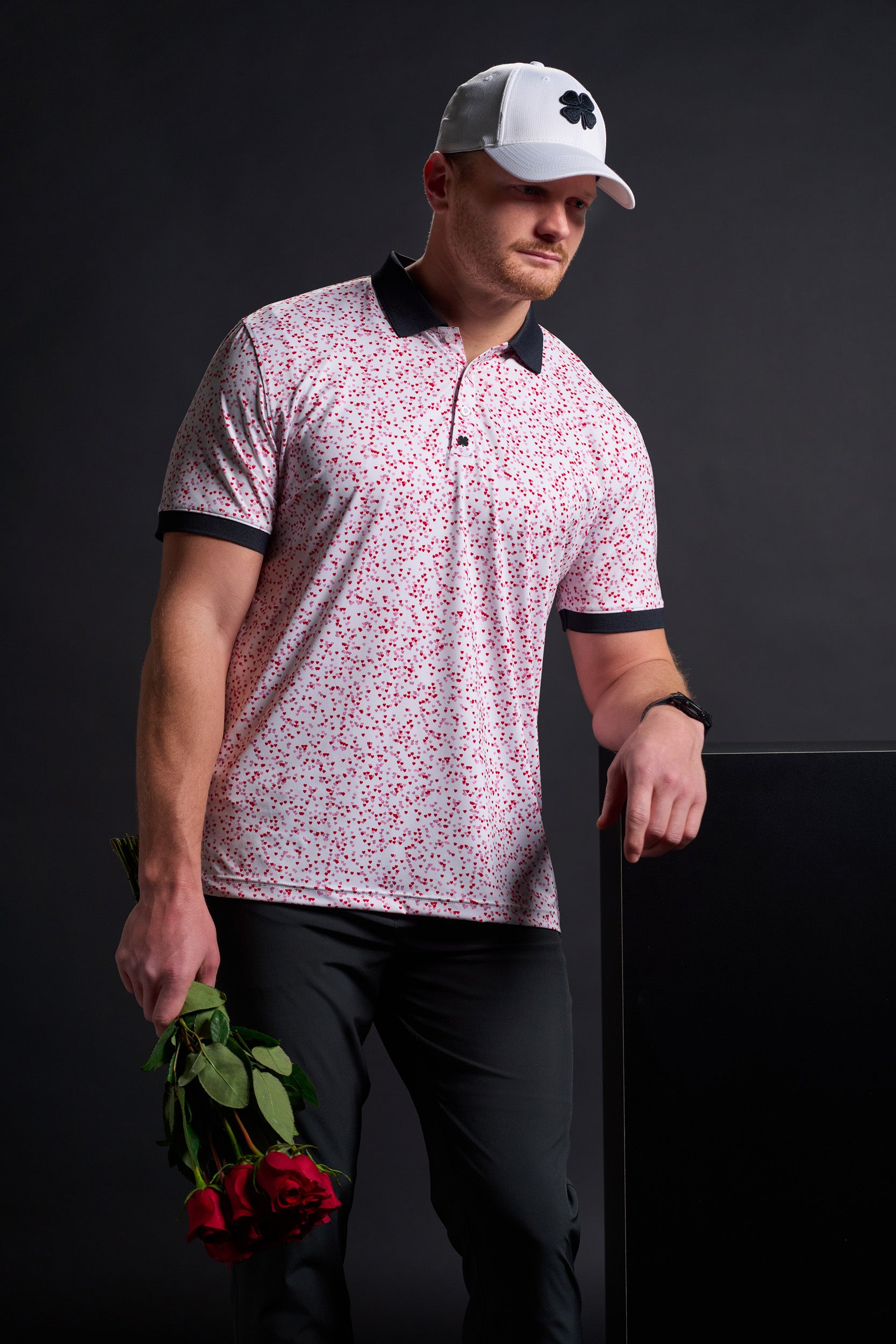 Man wearing Black Clover Live Lucky apparel with roses in his hand.