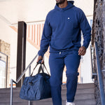 Man wearing Black Clover Live Lucky Cole hat and matching blue sweat suit. 